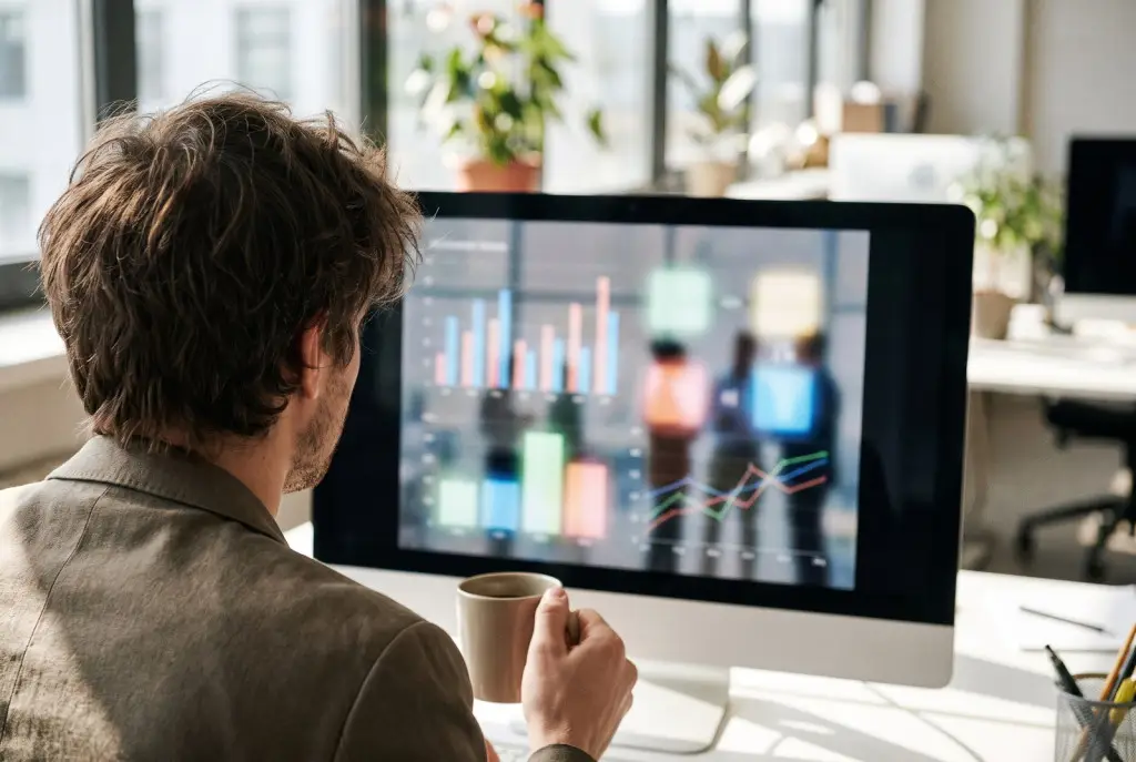 Marketing team planning an email marketing newsletter and automation for a Lubbock business on a screen in a bright office, screen blurred with no readable text